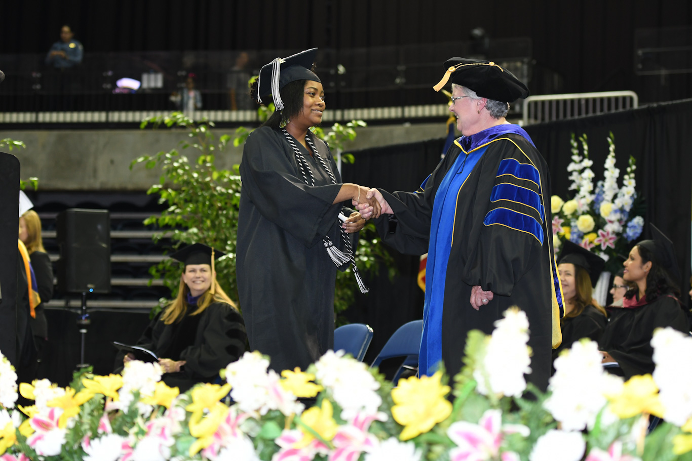 San Joaquin Delta College Superintendent/President Kathy Hart congraulates a graduate at the 2018 Commencement ceremony.