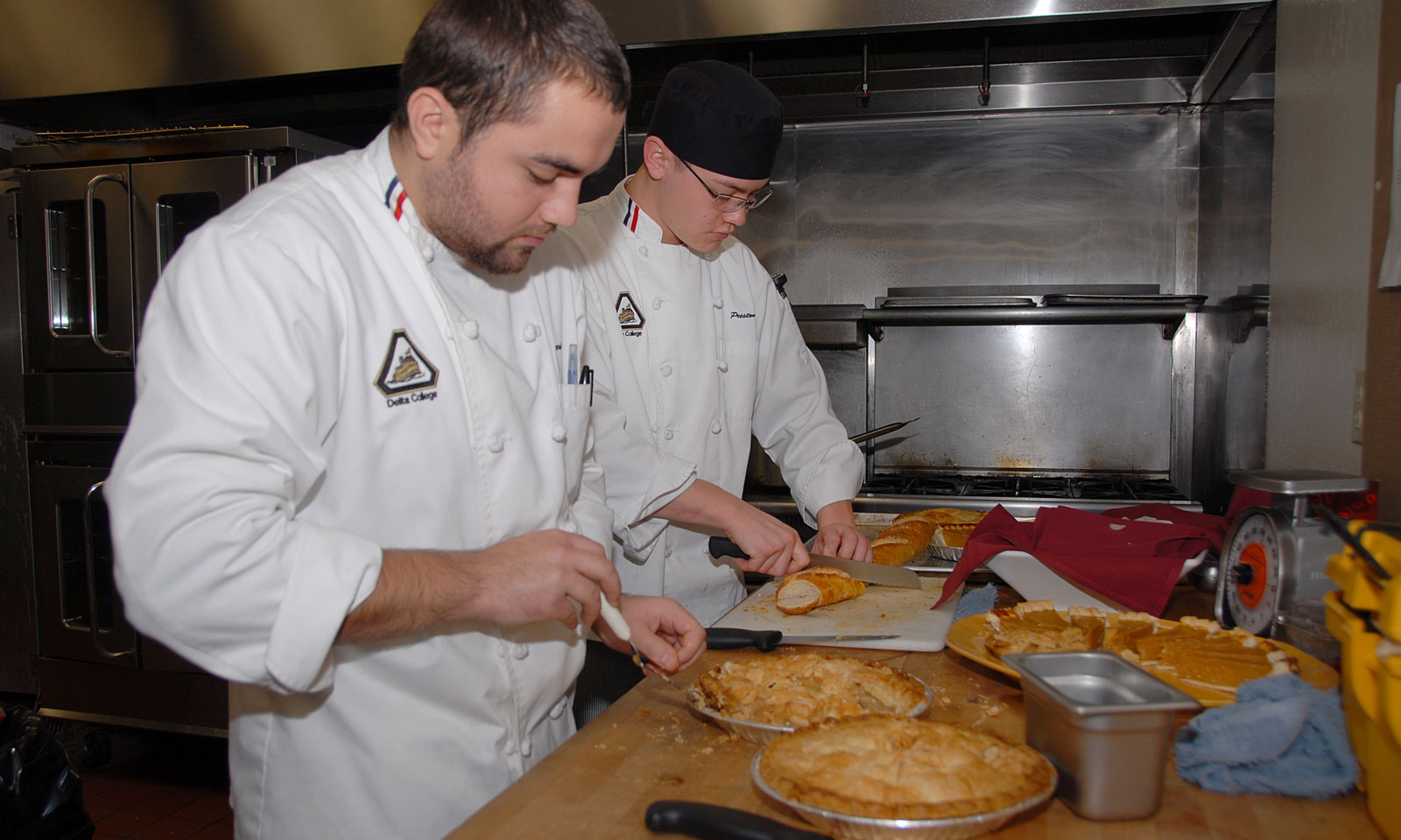 Students cut a pie during Culinary Arts Lab class.