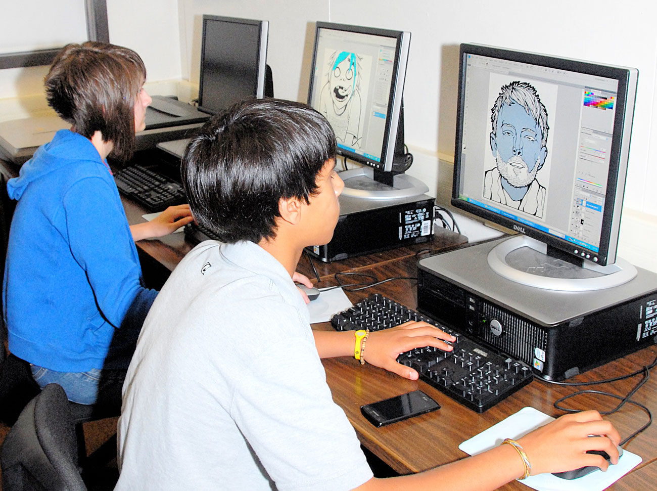 Graphic arts students work on computers