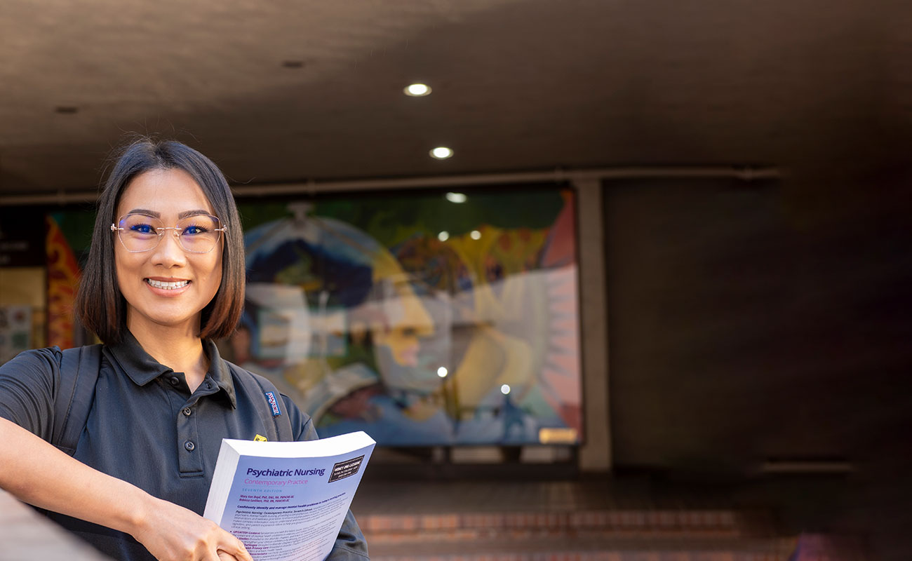 Student holding Textbook