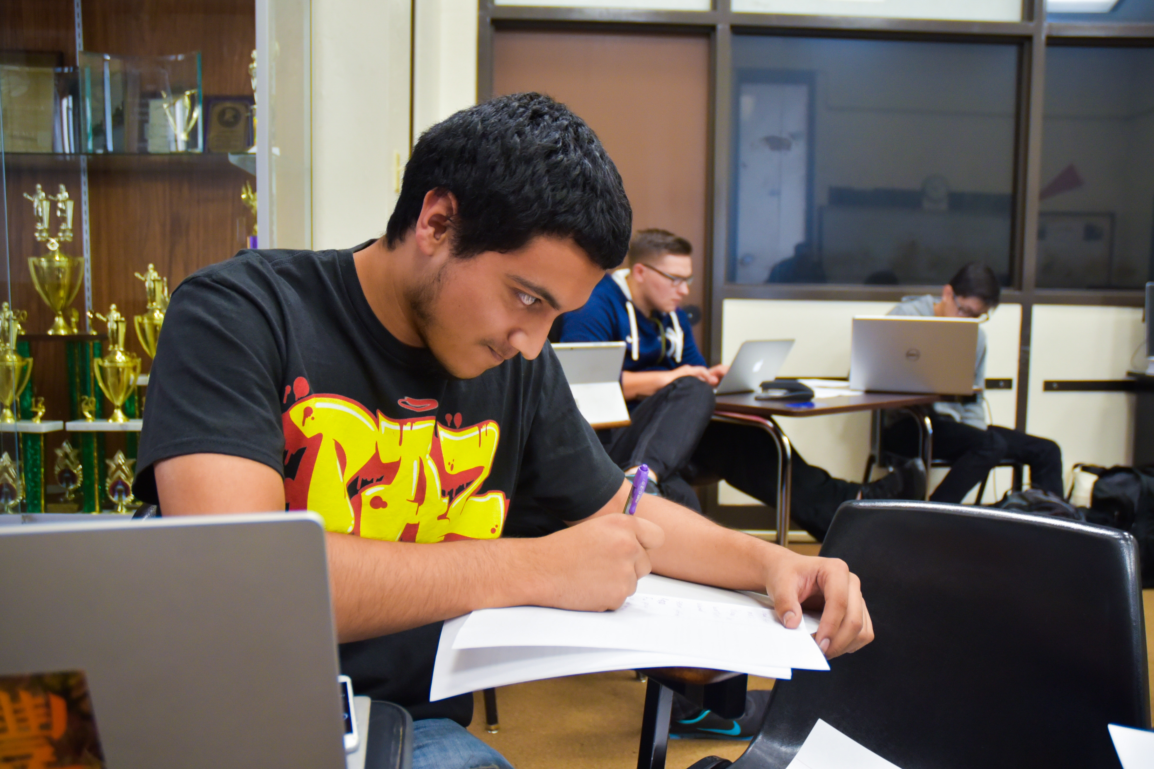 San Joaquin Delta College speech and debate team member Peter Perez jots down notes during his 20 minutes of prep time during a practice last week.