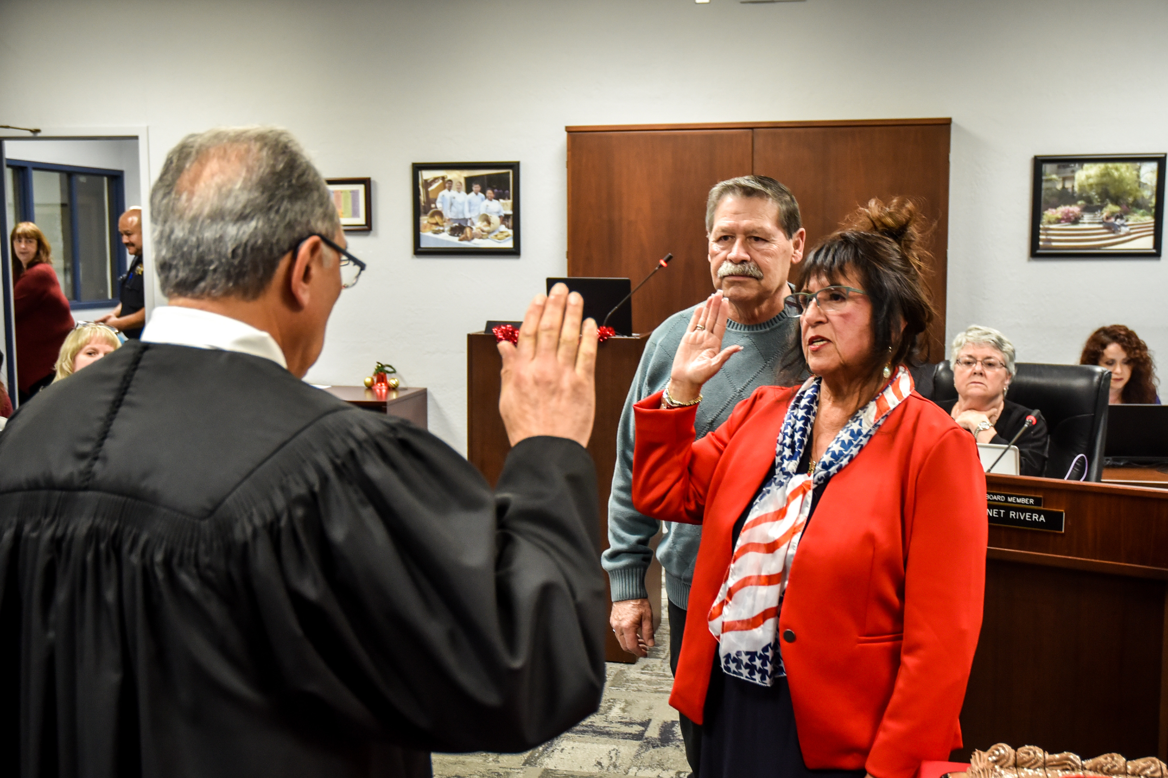 Returning San Joaquin Delta College Trustee Janet Rivera is sworn in while her husband, Rupert, watches.