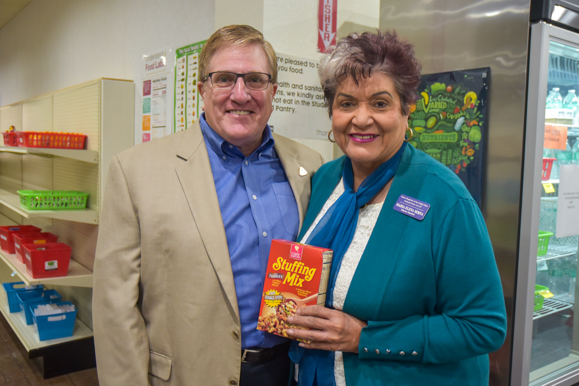 Delta College Trustee Charles Jennings, left, poses with Maria Elena Serna of the Native Daughters of the Golden West at the Student Food Pantry this week.