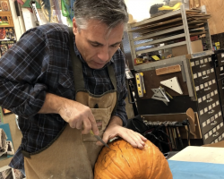 San Joaquin Delta College art professor Gary Carlos shows how to carve the perfect pumpkin. This pumpkin was auctioned off with the money going to student scholarships.