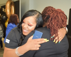 Se'Quoia Drew gets a hug from EOPS director Danita Scott at the 50th anniversary celebration for Delta's EOPS program.