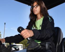 Young female student drives tractor
