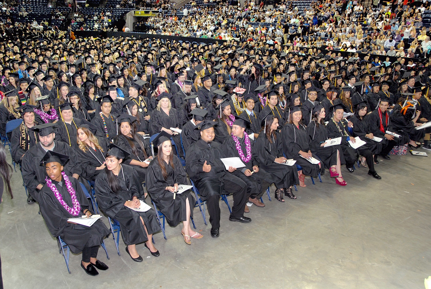 Students sit in the crowd at graduation
