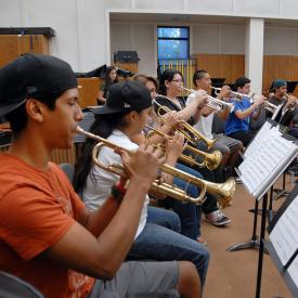 Students play trumpets in music class