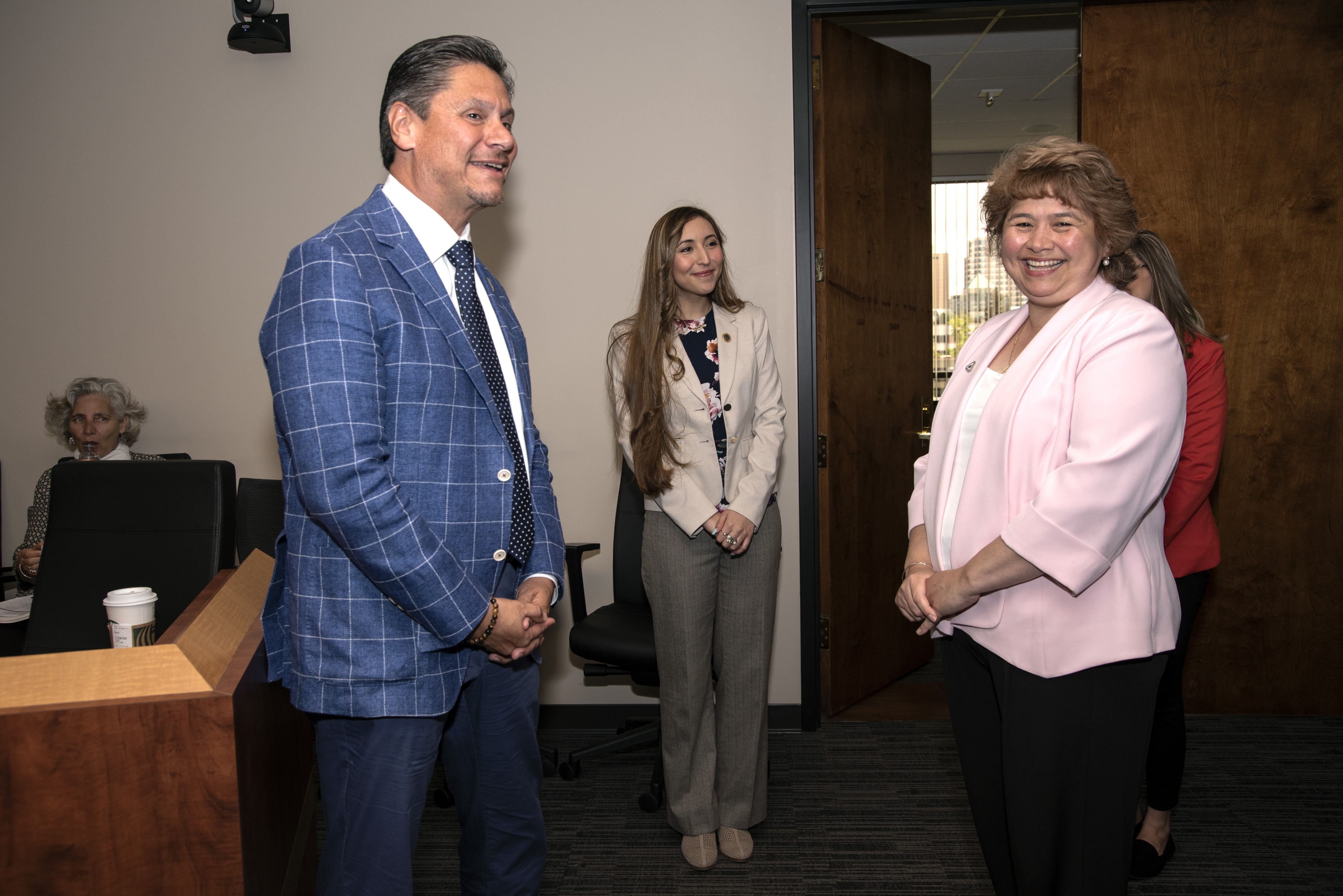 Delta College lab tech Trini Araya, right, enjoys a laugh with Chancellor Eloy Oakley after she was honored with a statewide classified employee of the year award.